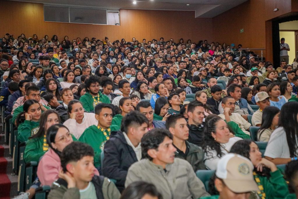 Cientos de estudiantes atendiendo a las explicaciones de la secretaria de educación.